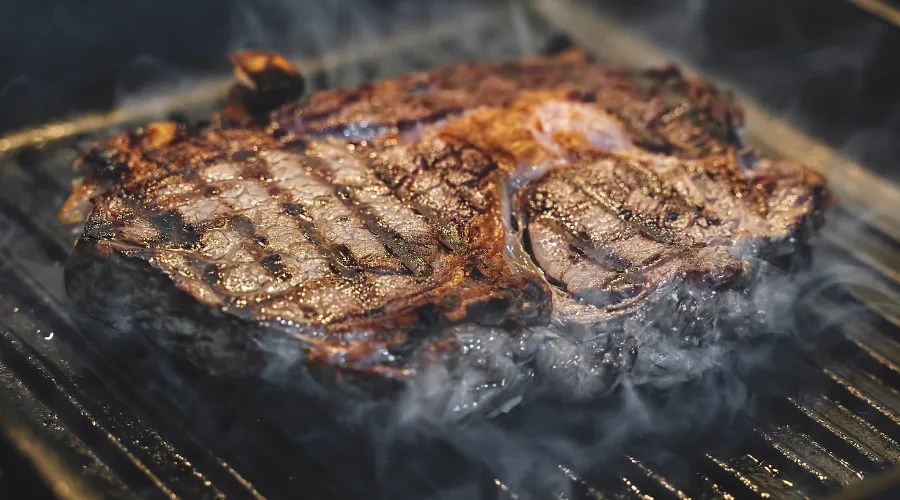 Steak cooking on griddle pan, searing meat