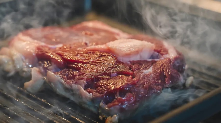 Steak cooking on griddle pan, searing meat