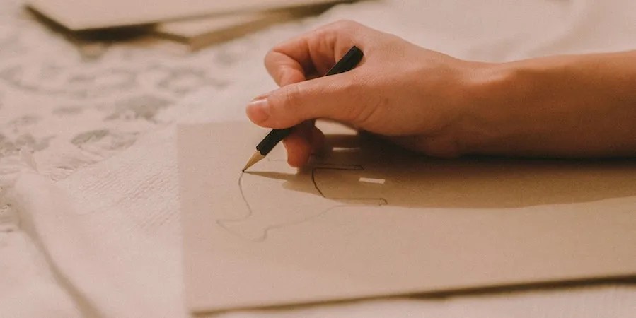 Person sketching on paper