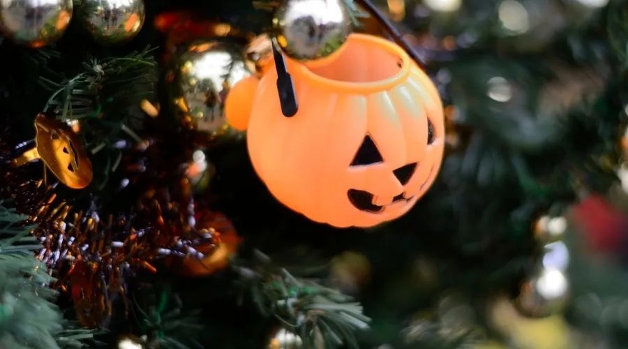 jack-o-lantern hanging on a Christmas tree