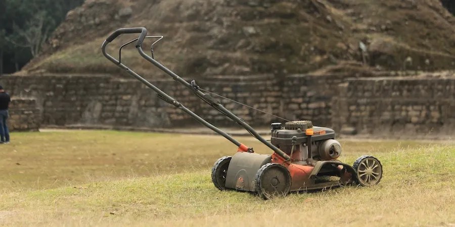 Lawnmower on brown grass