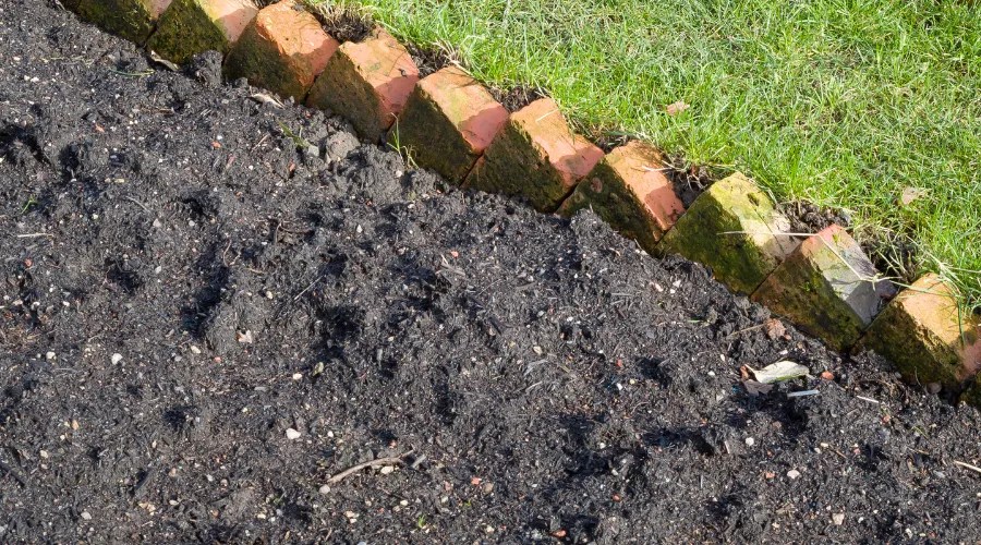 New garden flowerbed with brick edging, UK garden