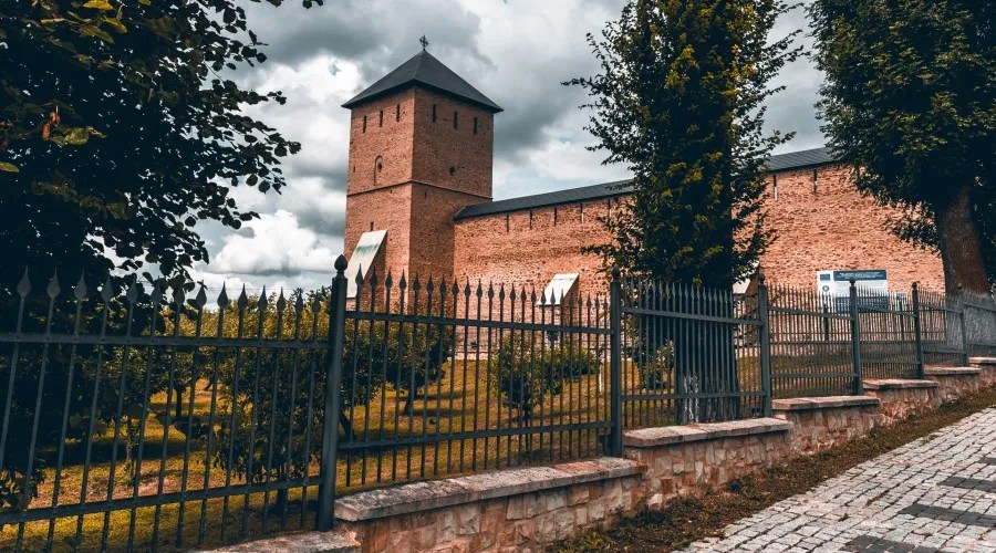 short brick fence with wrought iron on top