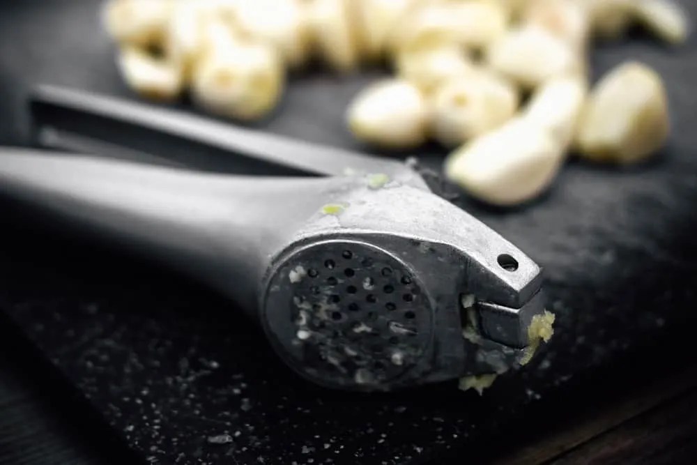 garlic press and cloves