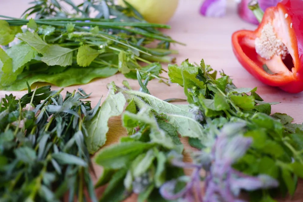 Sage and herbs on a cutting board.