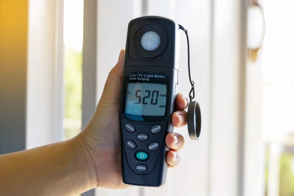 someone holding a light meter