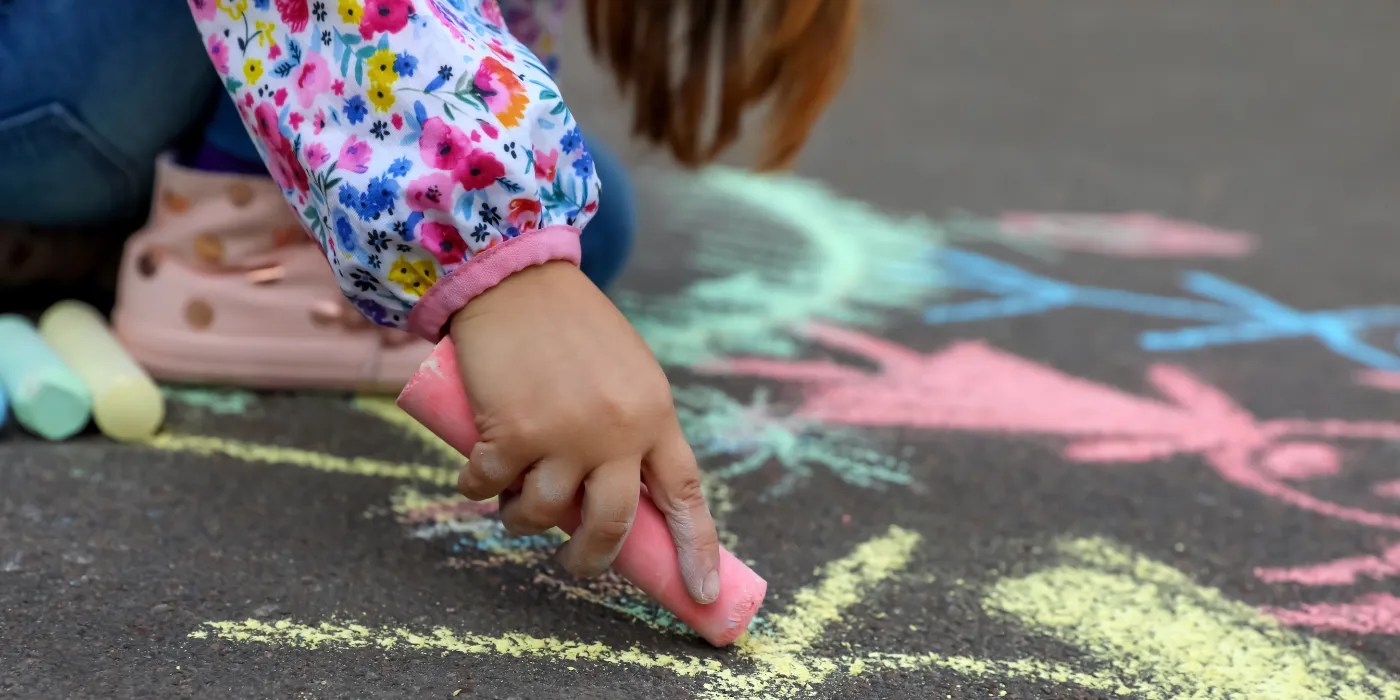 Child drawing with chalk