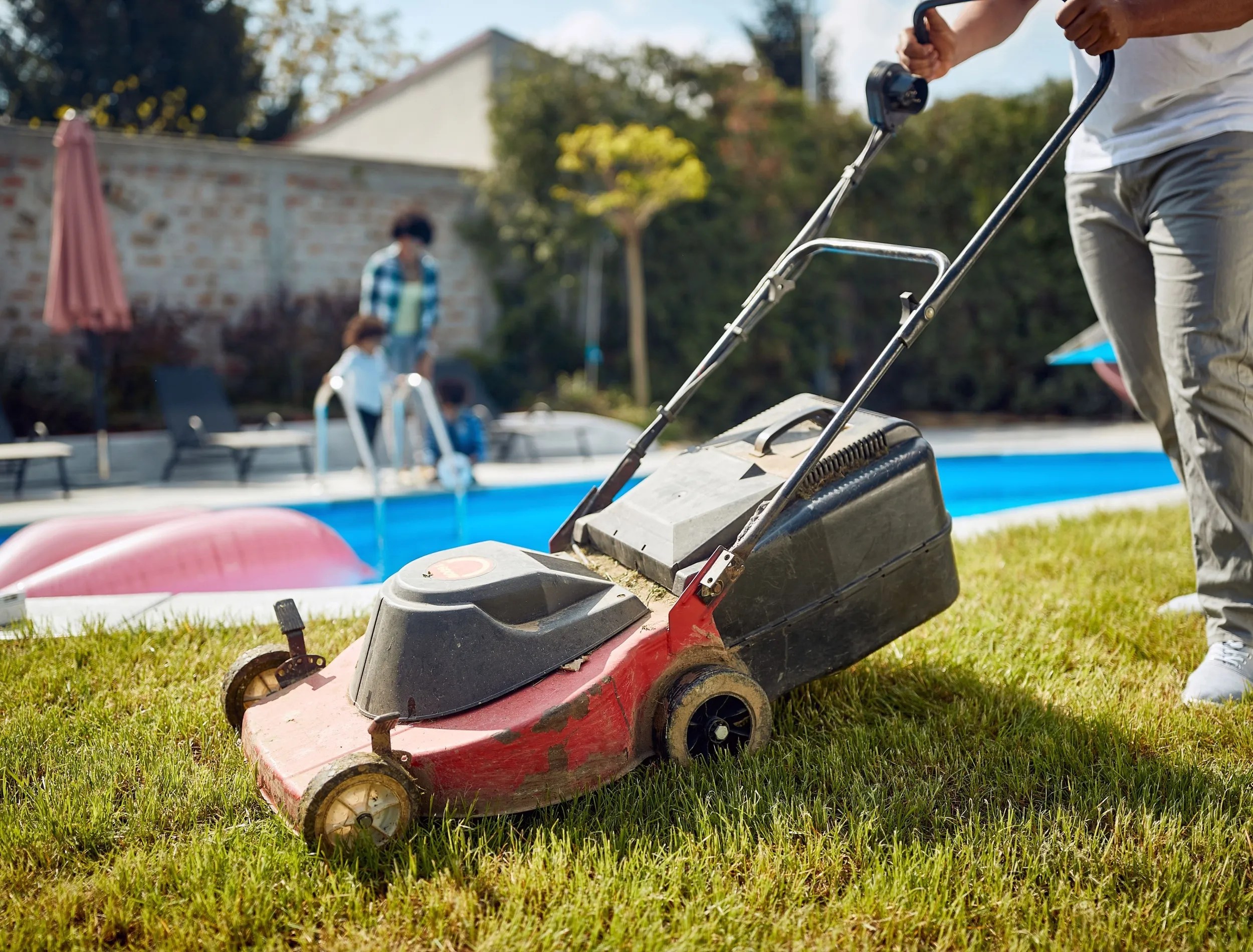 Mowing the lawn area around a pool