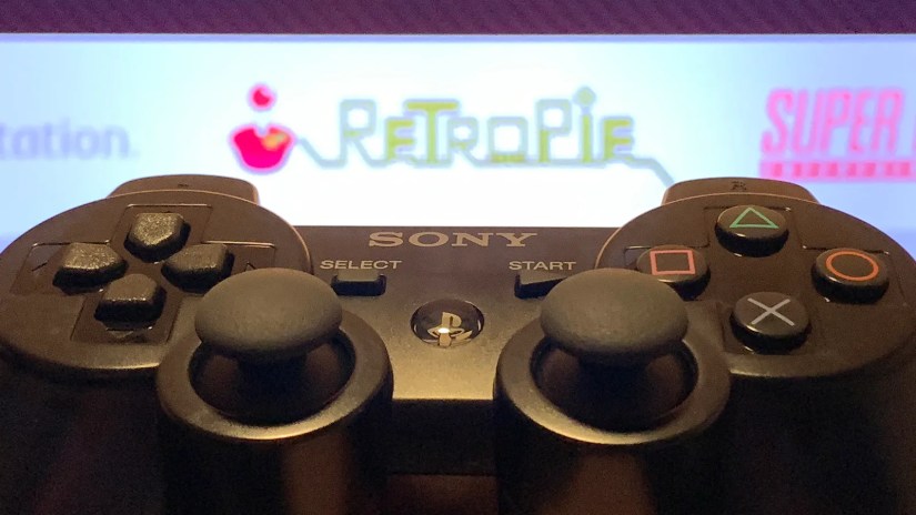 PS3 controller with RetroPie in the background.