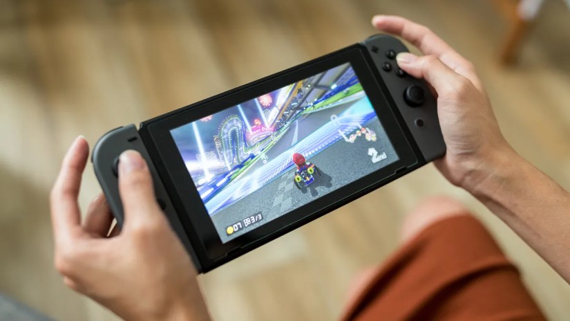 Person playing the Mario Kart video game on a Nintendo Switch