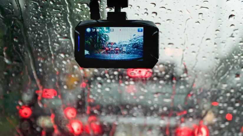 Car dash cam running mounted to a rainy windshield