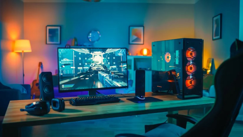 A modern gaming rig with a powerful PC tower and neon lighting.