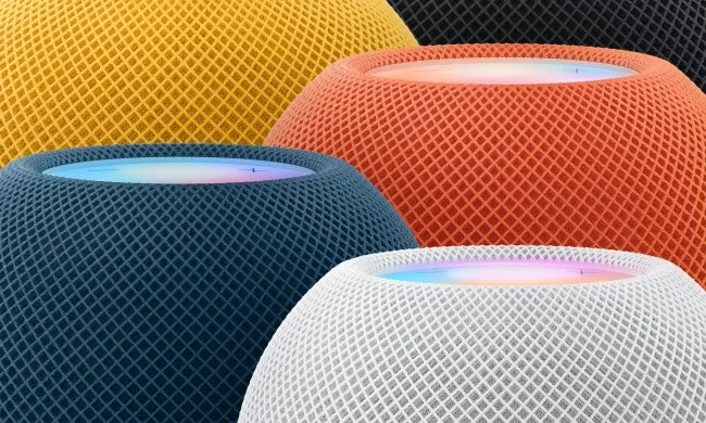 A collection of Apple HomePod speakers in different colors.