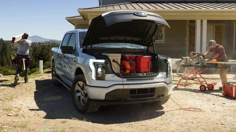 F-150 Lightning front trunk filled with gear and using the AC outlets.