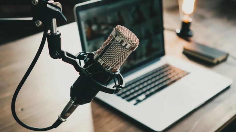 Home studio microphone in front of a laptop.