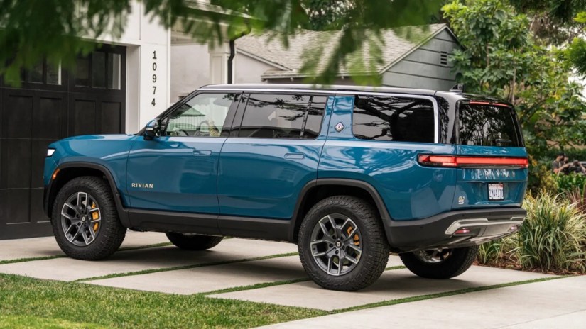 Blue Rivian R1S parked on a driveway.