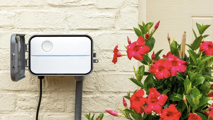 Rachio smart irrigation timer mounted on wall outside.