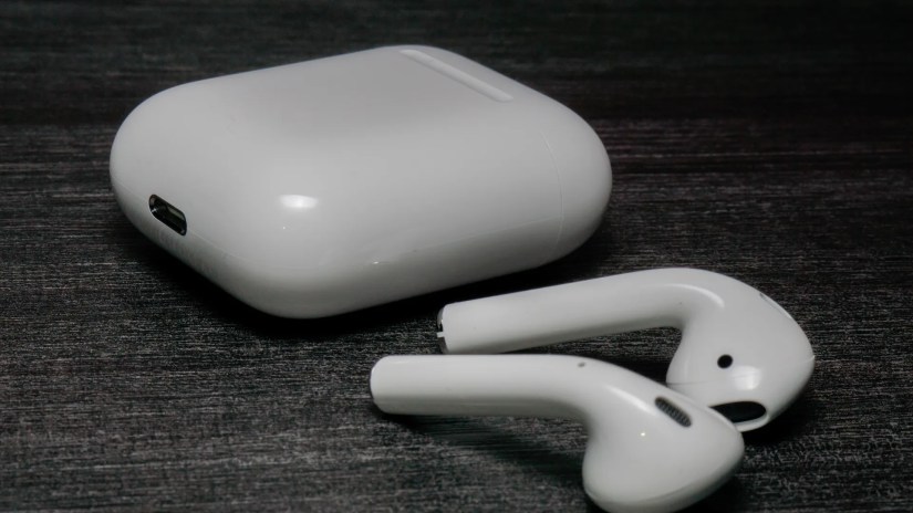 AirPods and case sitting on a table.