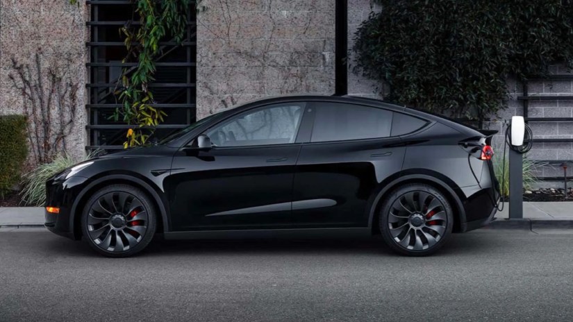 Tesla car and EV charger in public