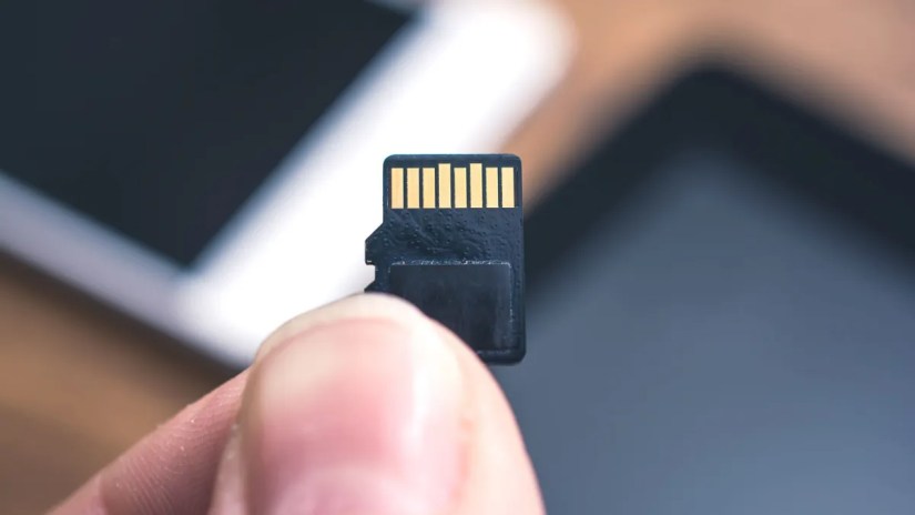 MicroSD card in someone&rsquo;s hand.