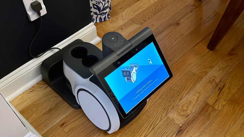 Amazon Astro setting up while sitting on its charger