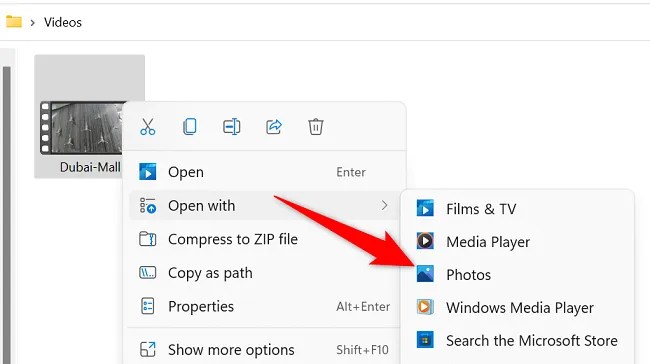 Right-click the video and choose Open With &gt; Photos.