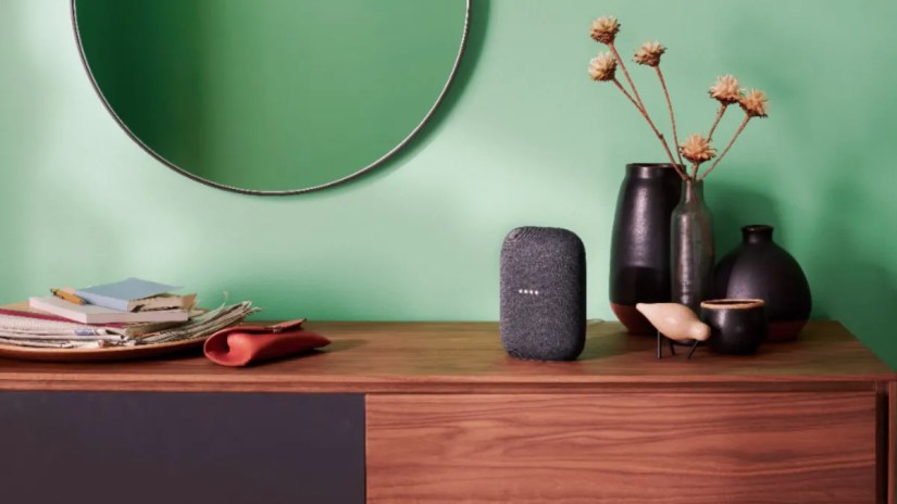 Google Nest Audio smart speaker sitting on a desk.