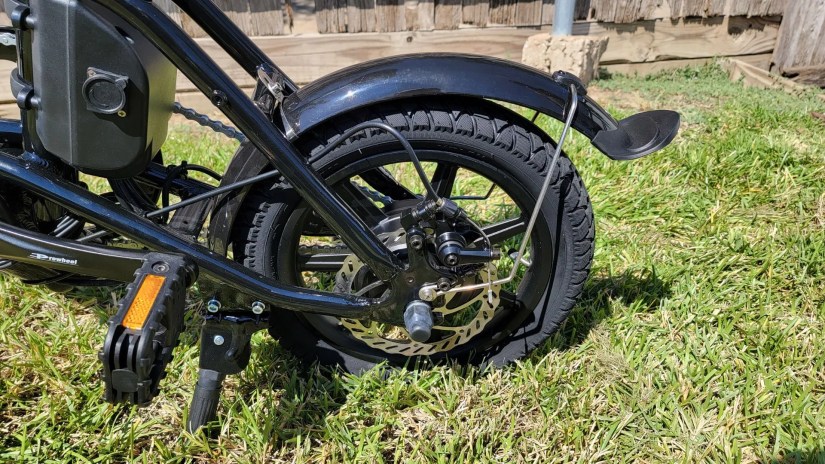 Rear wheel of Fiido D3 Pro Mini Electric Bike parked on grass