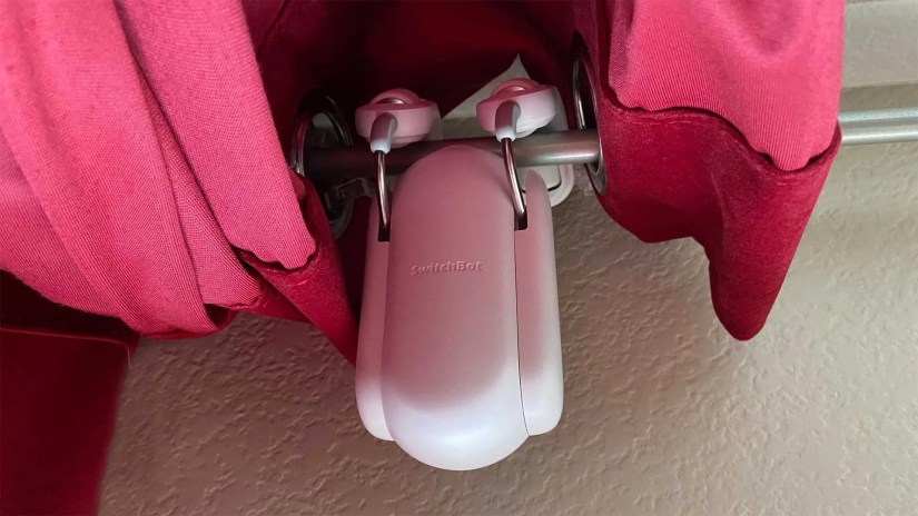 SwitchBot Curton Rod smart curtain opener installed on rod.