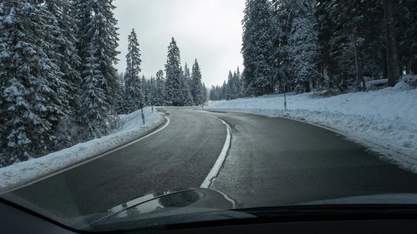 electric car driving in snowy mountains