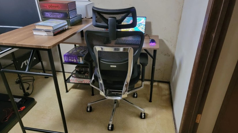 back view of OdinLake Ergo Plus 743 ergonomic chair pushed up to a desk