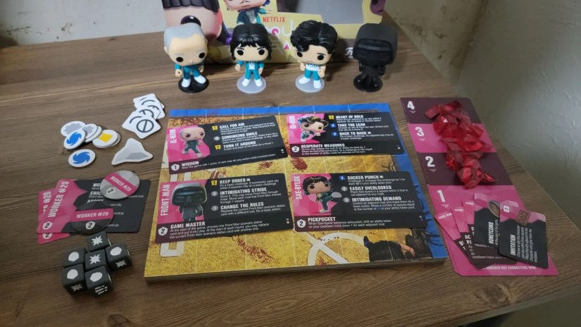 Funkoverse Squid Game strategy board game contents on wooden desk