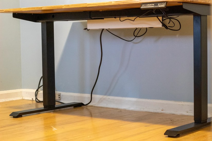 The legs of a standing desk with no crossbar