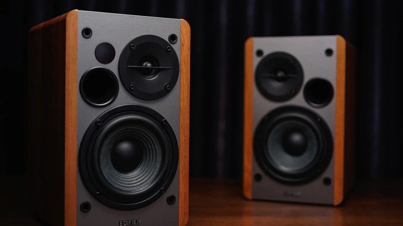 A set of Edifier bookshelf speakers in a dark room.