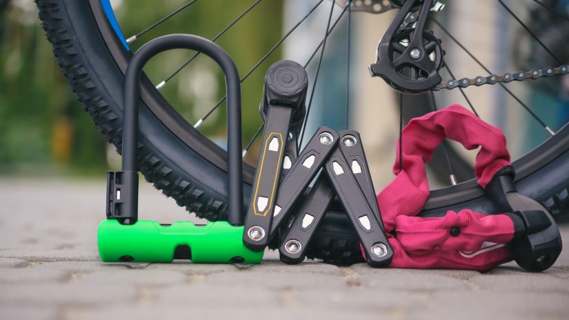 Different bike lock styles sitting on a tire.