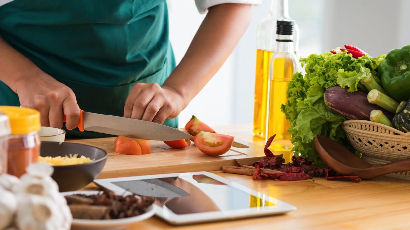 Cooking: Close up of vegetable chopping.