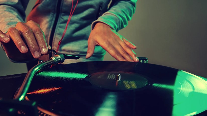 A DJ spinning a vinyl record.