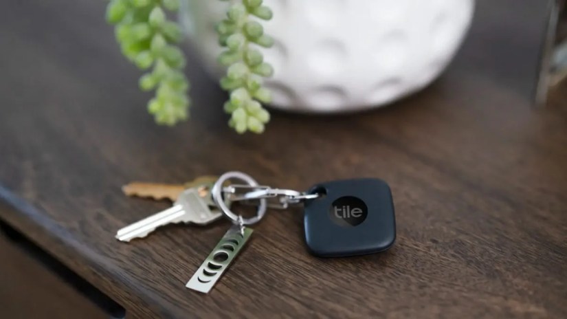 A Tile Bluetooth tracking sitting on a side table.
