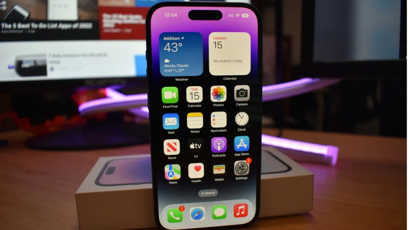 iPhone 14 Pro with display on resting on original box