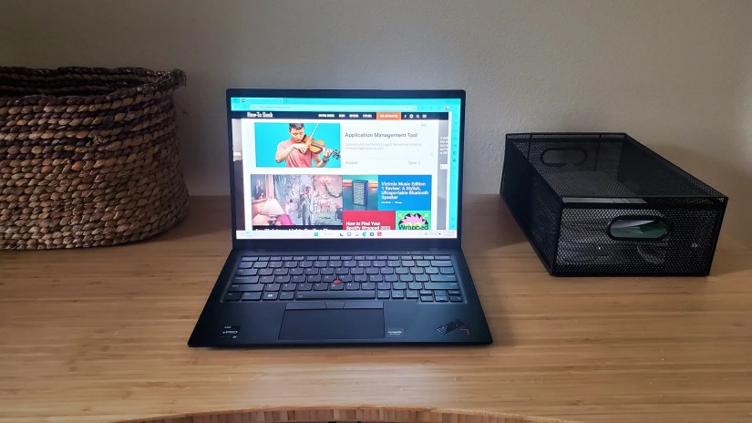 The Lenovo ThinkPad X1 Carbo laptop sitting open on a desk.