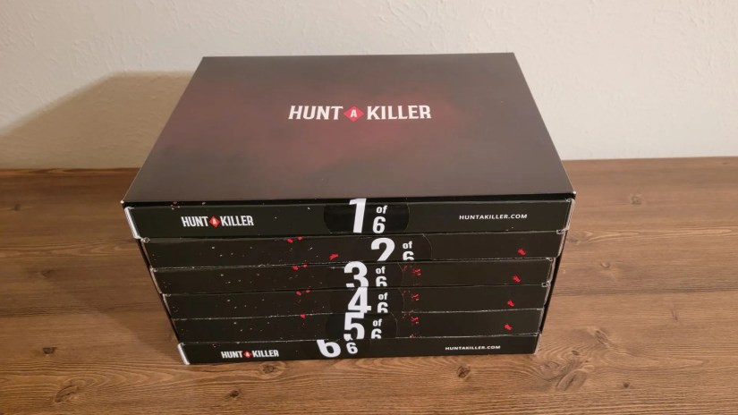 Hunt A Killer Curtain Call Box Set sitting on wooden desk