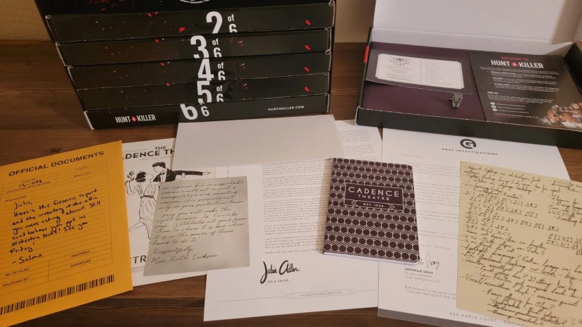 Box one contents of Hunt A Killer Curtain Call Box Set laid out on desk