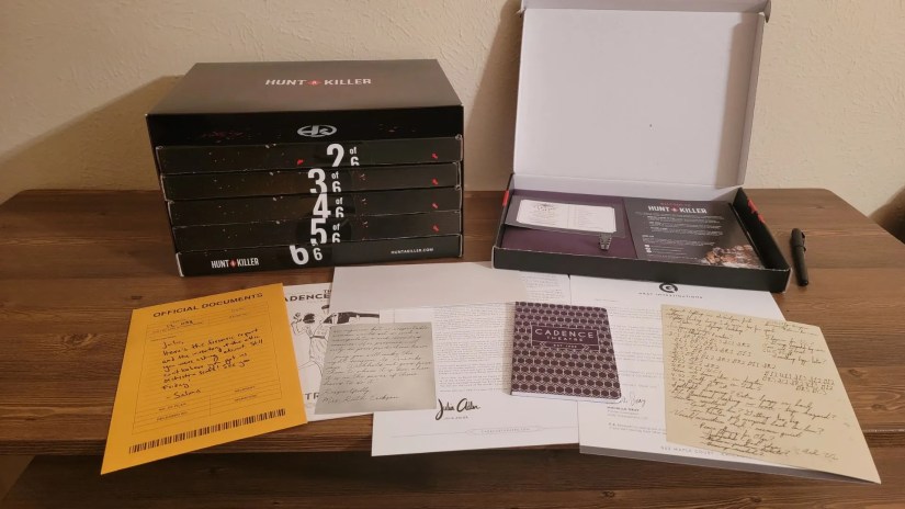 Contents of box one of Hunt A Killer Curtain Call Box Set laid out on desk