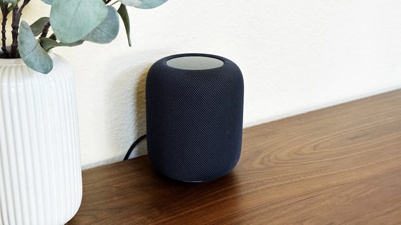 HomePod sitting on a cabinet showing its power cord