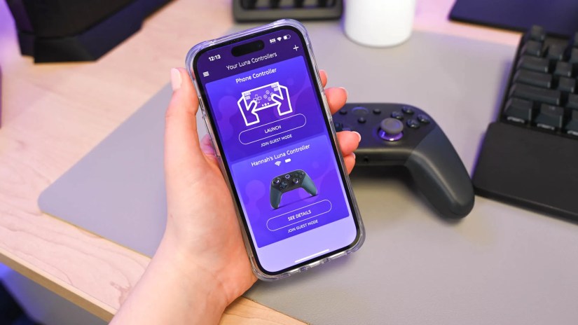 A person holding a smartphone with Amazon Luna app showing