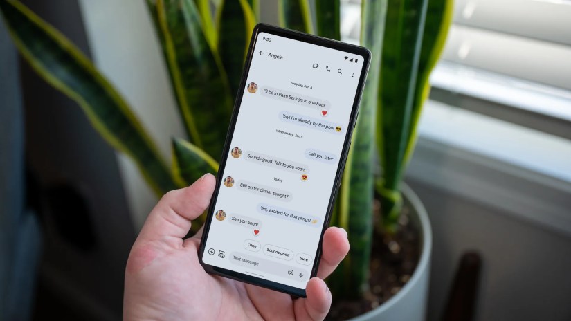 Android phone with text messages on screen.
