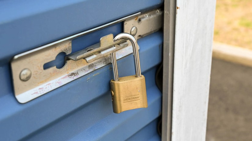 A master lock securing the latch on a storage unit