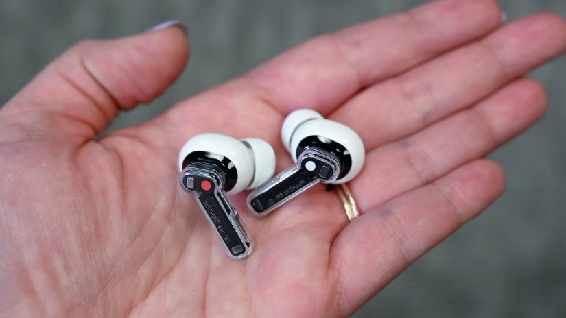 Person holding a pair of Nothing Ear 2 earbuds