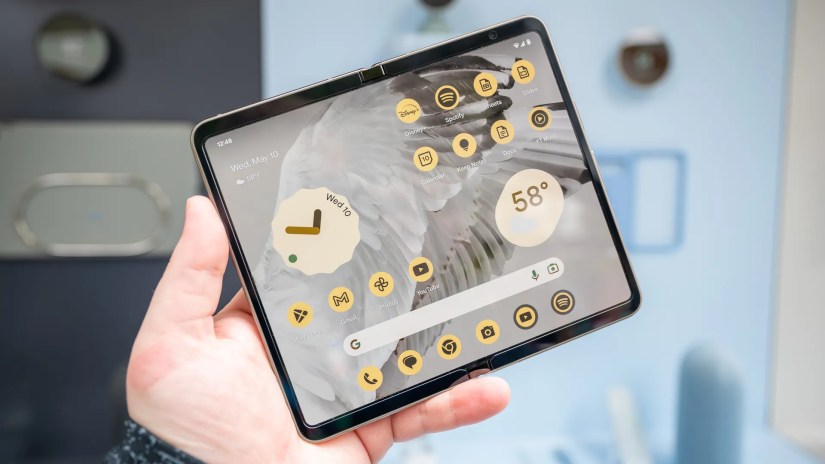 Person holding the Google Pixel Fold with the internal screen open