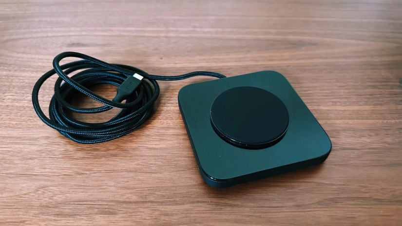 Showing the Nomad Base charger with its 2-meter cable coiled up next to it